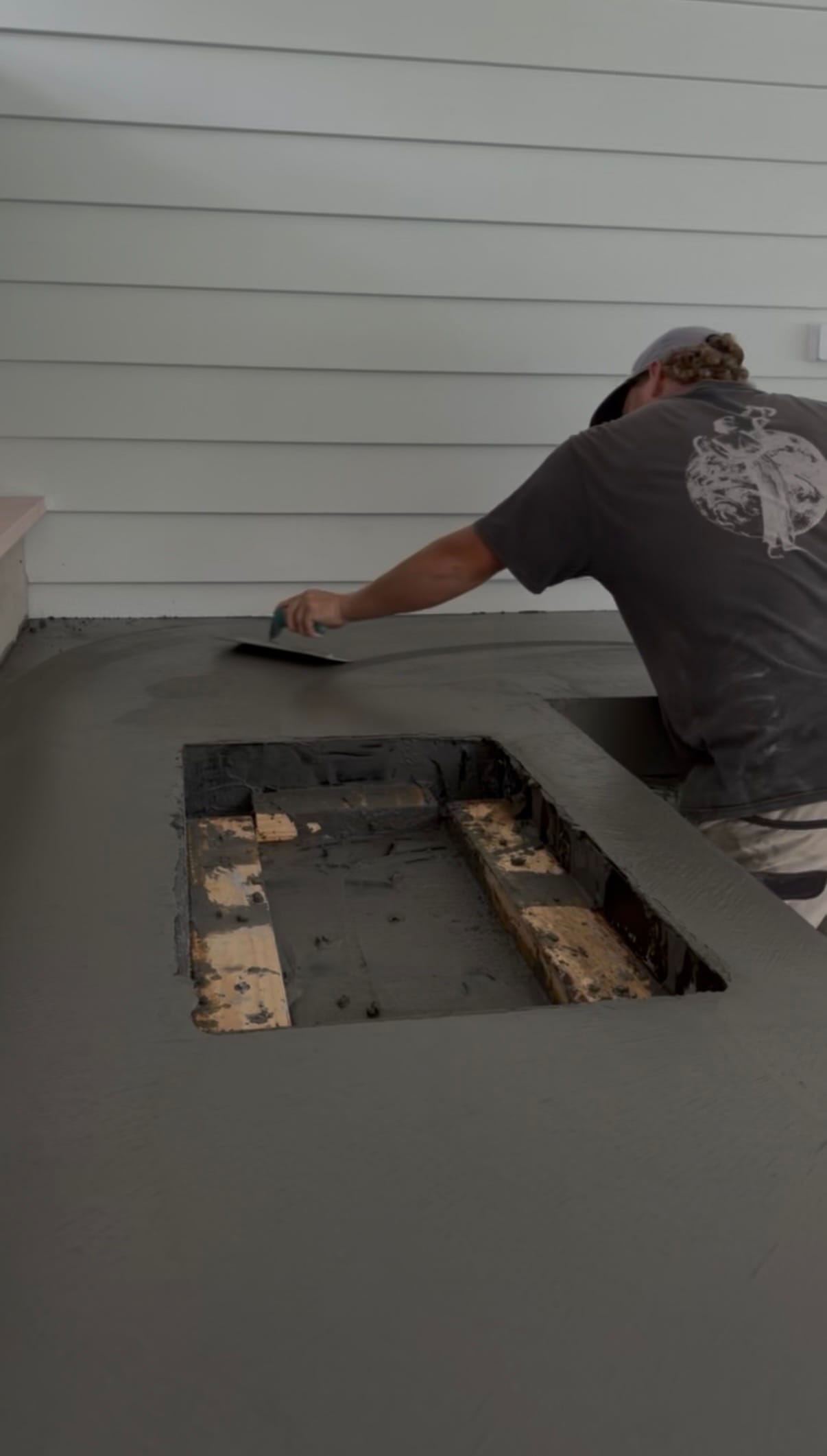 Hand finishing architectural concrete benchtop at Avalon