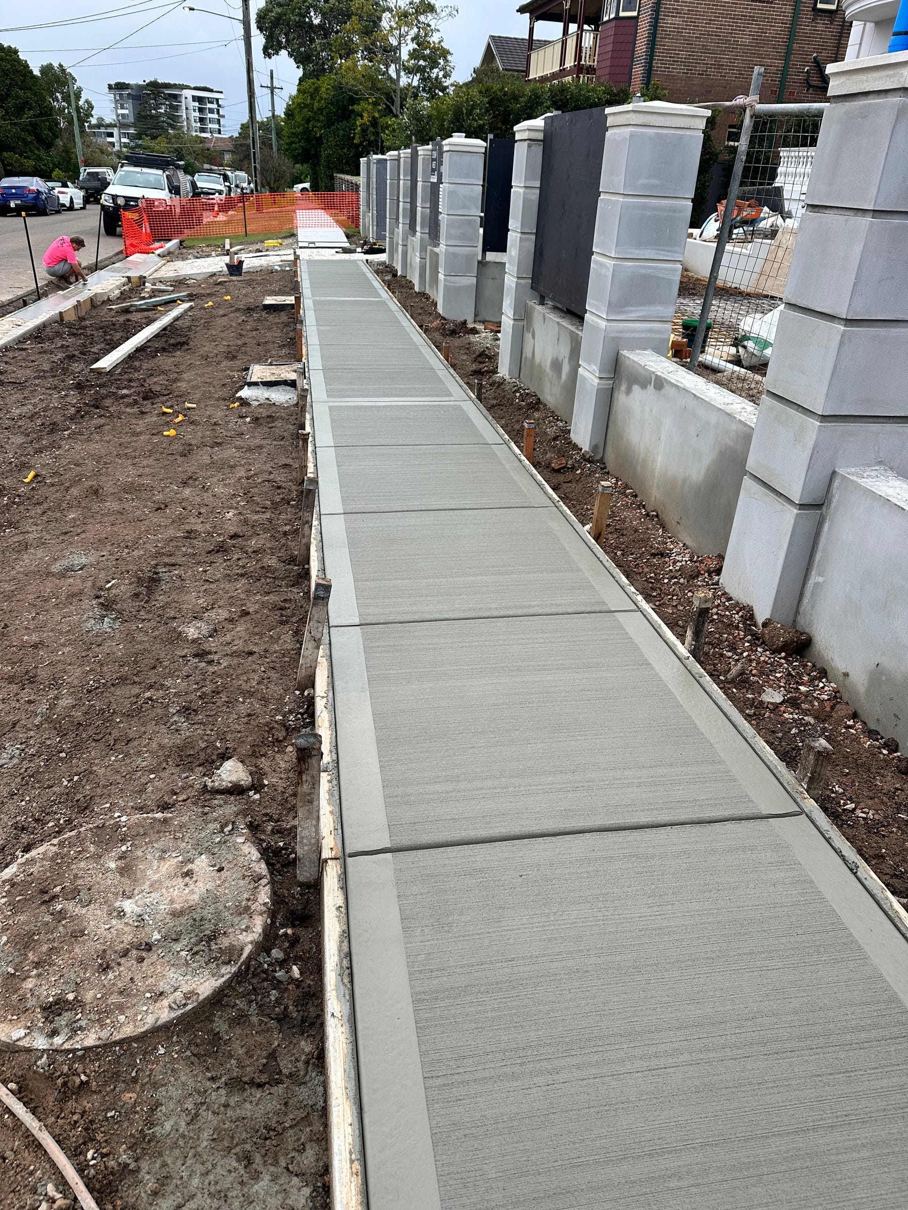 Concrete footpath with clean edges through a landscaped garden