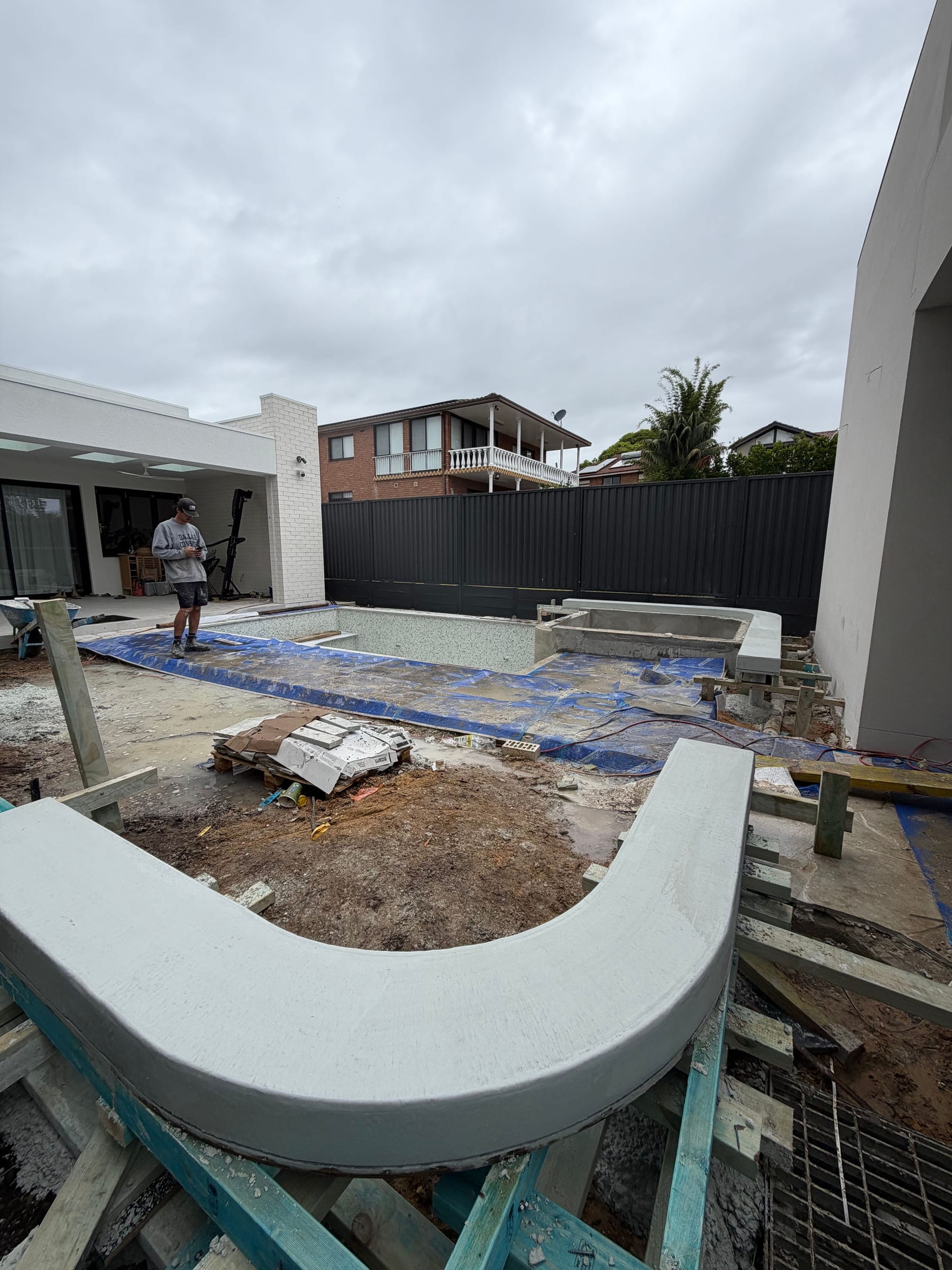 Freshly poured architectural concrete seating and spa surrounds at Zetland