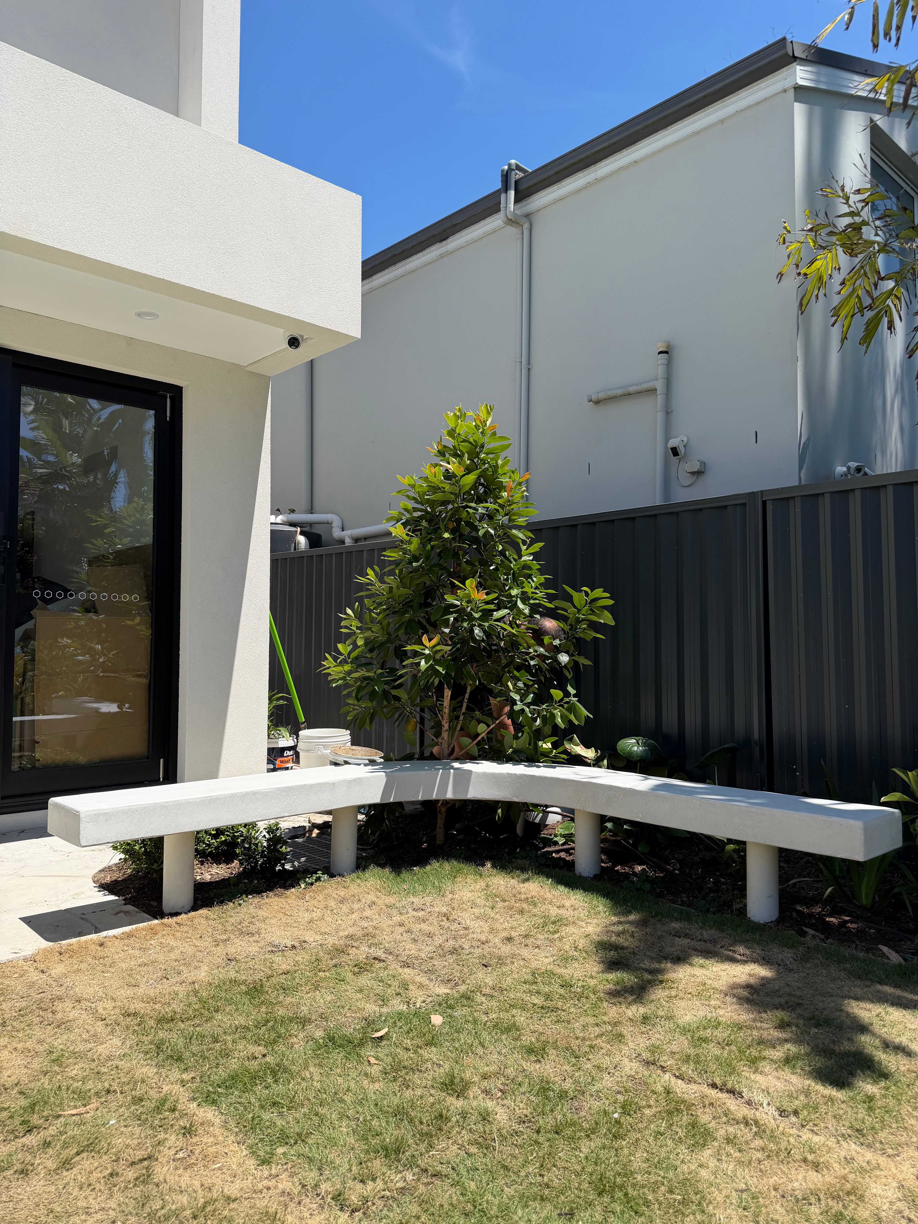 Curved floating architectural concrete bench