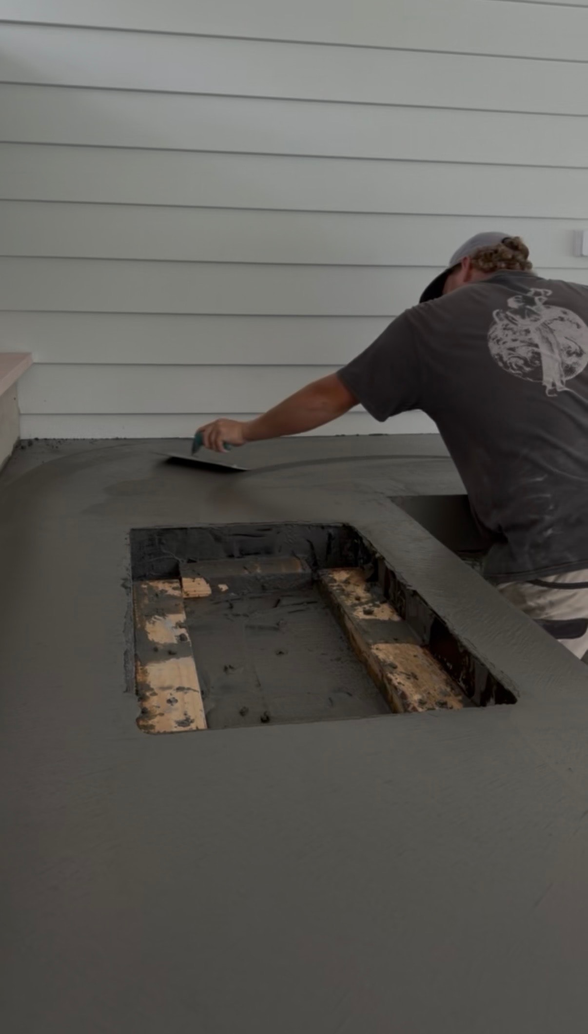 Hand finishing architectural concrete benchtop at Avalon
