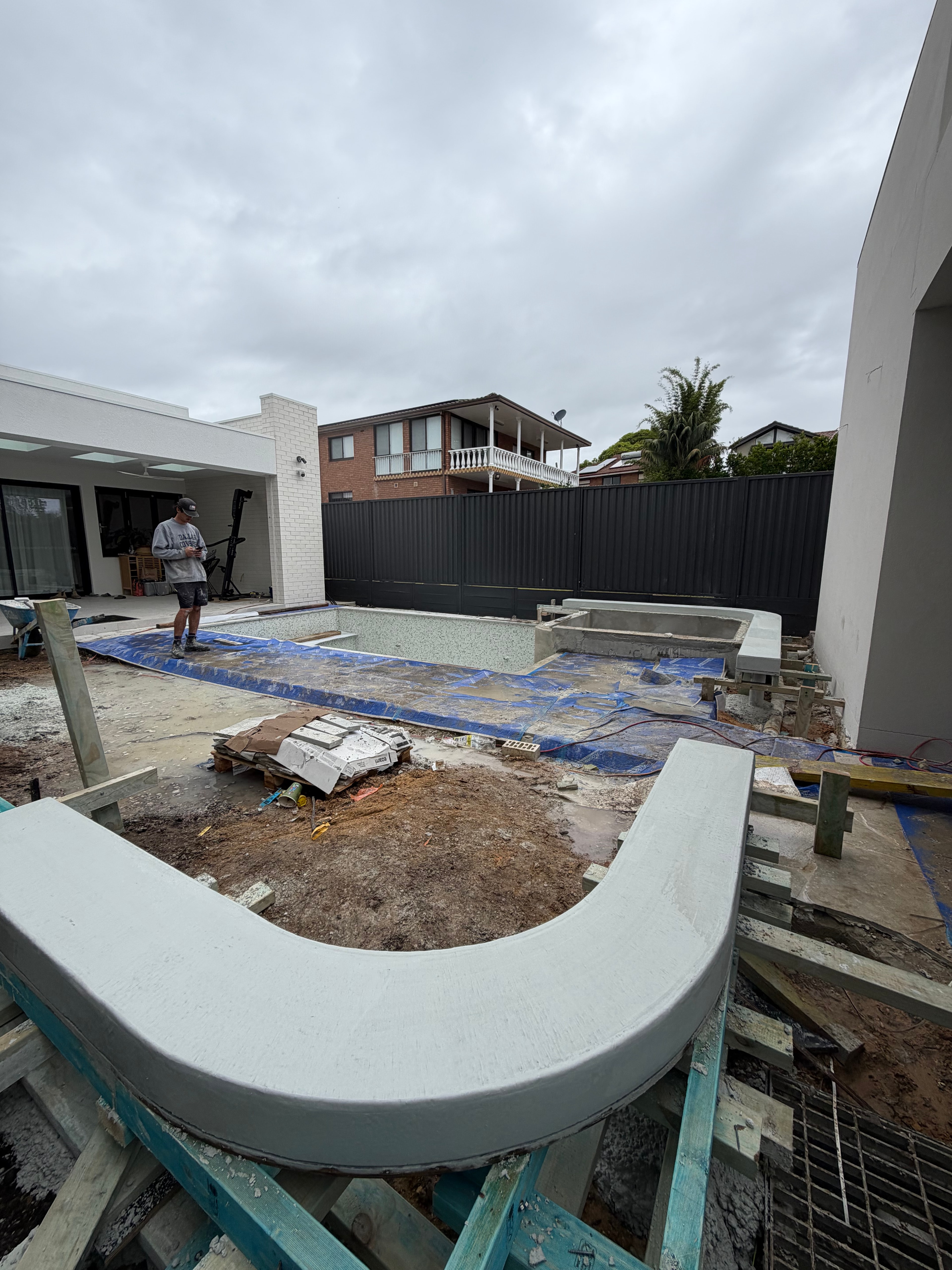 Freshly poured architectural concrete seating and spa surrounds at Zetland